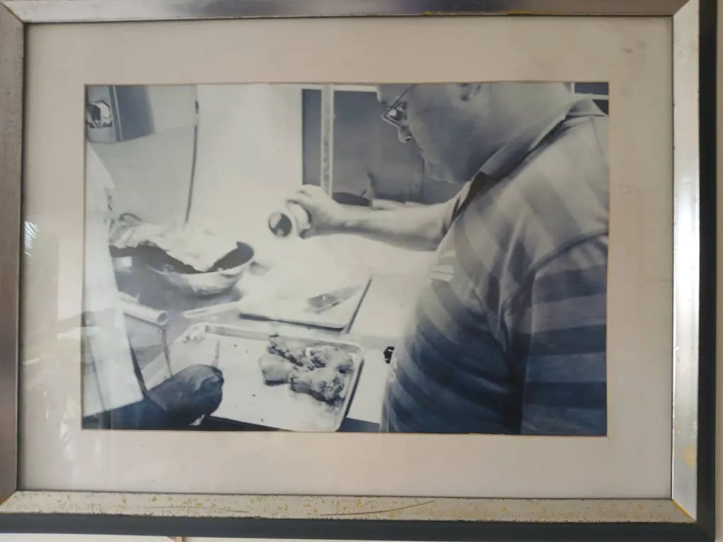 Framed archive photo of food being prepared in a kitchen