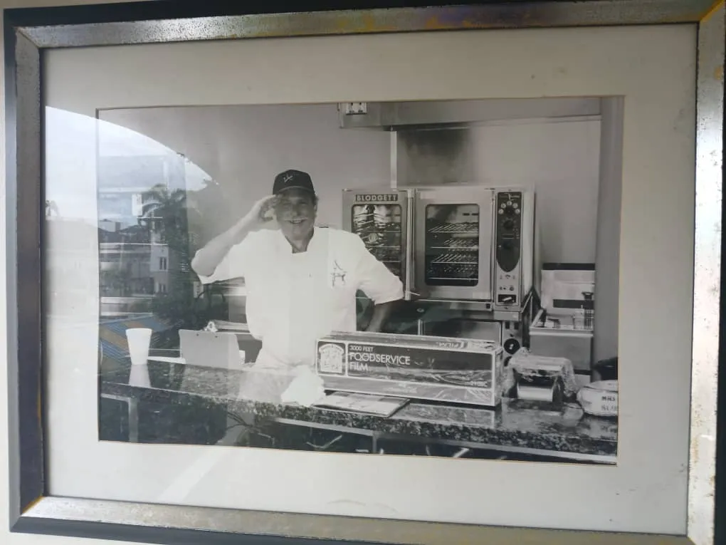 Framed archive photo of a chef at a service counter